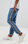 ASOS DESIGN slim jeans in mid wash blue with rainbow stripe
